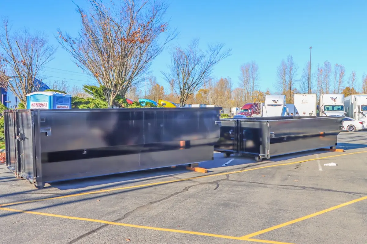 Professional dumpster rental service with roll-off container on residential driveway in East Hanover